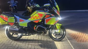 Stationary motorcycle with dayglow orange and yellow markings